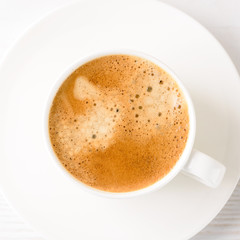 Coffee foam texture close up in cup on top view.