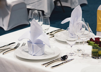 Table setting in the restaurant, water in the grass on the dining table, glass of water on table