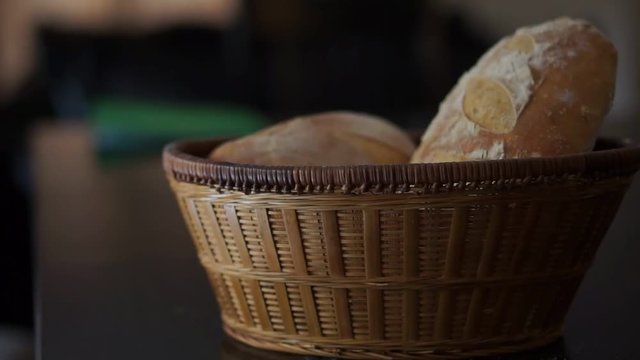 a rustic country wicker basket full of sourdough bread in sunlight