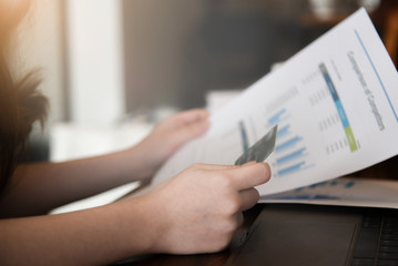 Business woman analysed report of profit finance data graph document in her office