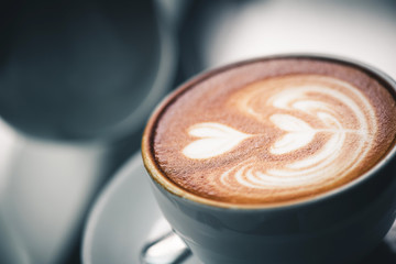 Latte coffee or coffe on wood table at cafe in the morning 