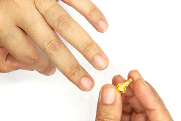 woman hand putting a wedding ring isolated on black background.