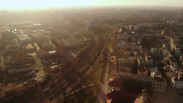 Lift aerial movement of Old Town Constanta, Romania, Europe. Shot in spring during sunset and Golden Hour, revealing the History Museum, architecture and traffic, while seagulls fly