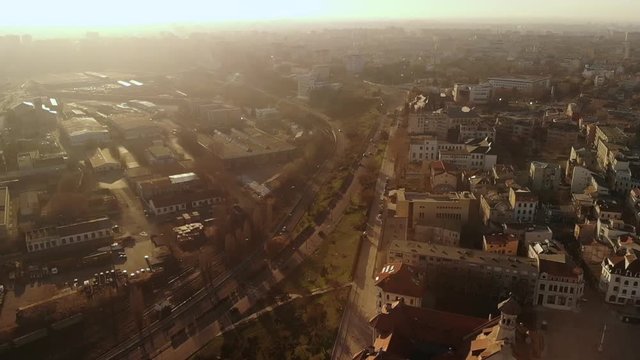 Lift drone of the Old Town of Constanta, Romania, Europe, shot in spring during sunset and Golden Hour, revealing the architecture and traffic while seagulls fly
