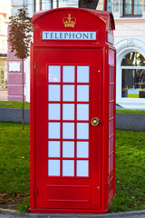 Fototapeta premium Traditional old style red telephone box, british phone booth in Ukraine