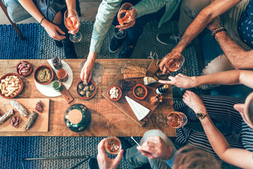top view of a group of people around a table enjoying food and friendship  - obrazy, fototapety, plakaty