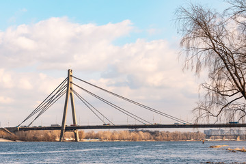 Fototapeta na wymiar The cable-stayed bridge Pivnichnyi (ex Moskovsky) bridge, built by Heorhii Fuks, under a cloudy sky, in Kiev, Ukraine.