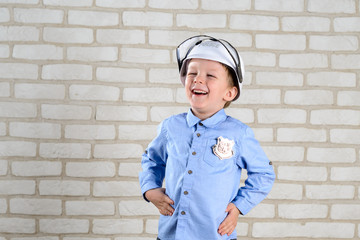 portrait 4-year-old boy plays policeman, childhood dreams, choice of profession
