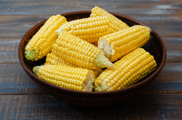 Ripe corn in a clay bowl. 