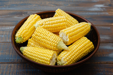 Ripe corn in a clay bowl. 