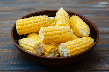 Ripe corn in a clay bowl. 