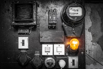The old cabinets with wiring and piping of the electrical system control in small factory for...