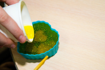 Process of homemade soap, mixing lye solution into oil. Making a gift with your own hands.