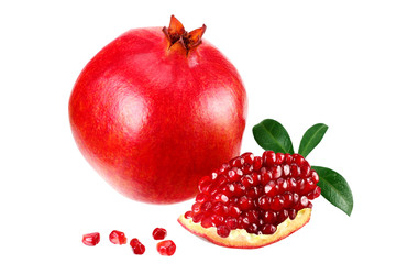 piece of pomegranate with seeds and green leaves isolated on a white background.