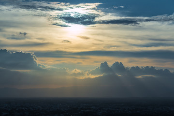 Beautiful clouds with sunshine passing through the sky at sunset.