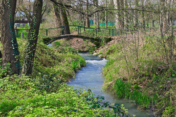 Fototapeta na wymiar Bridge on little river in Pellerina park, Turin, Piedmont, Italy