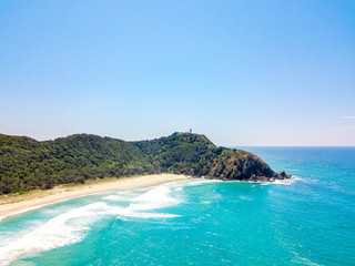 Tallows Beach at Byron Bay from an aerial view with blue water