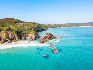 The Pass at Byron Bay from an aerial view with surfers and blue water
