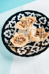 Baklava on plate. Pastry made of layers of filo filled with chopped nuts and sweetened and held...
