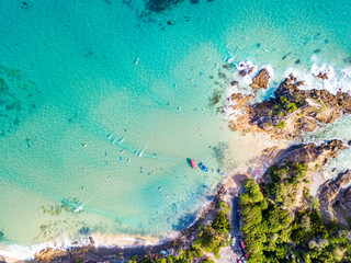 The Pass at Byron Bay from an aerial view with surfers and blue water