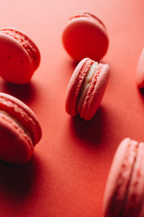 Composition of delicious pink macaroons on red table sweet dessert