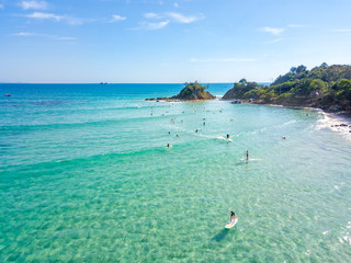 The Pass at Byron Bay from an aerial view with surfers and blue water