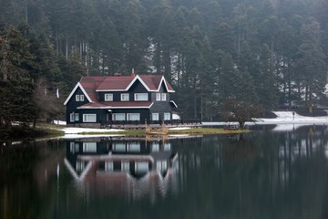Fototapeta na wymiar Wooden Lake house inside forest in Bolu Golcuk National Park, Turkey 