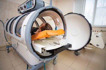 young guy in a hyperbaric chamber, oxygen treatment, medical chamber