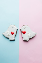 Two cookies in heart shape two doves with glaze