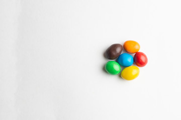 Fototapeta na wymiar Colorful chocolate candies on the white background