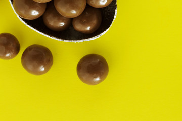 Chocolate eggs in bird nest , Easter holiday decorations , Easter concept background. Eggs hunt.