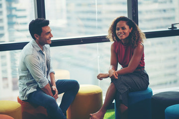 Businessmen, men and women are talking comfortably and smiling.