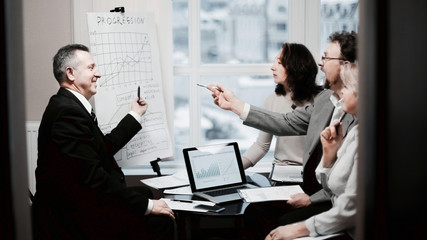 confident businessman showing business partners a new commercial