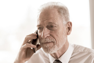 Senior businessman talking on mobile phone