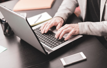 Hands of businessman using laptop