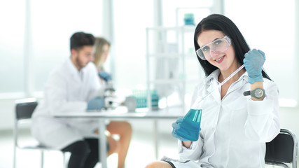 close up.female laboratory assistant takes a sample of the liquid