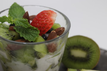 Kiwi Fruit with Yogurt , Topped with Red Strawberry and Mint on White Background