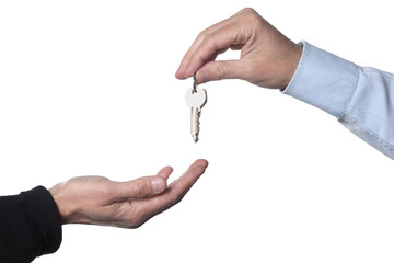 real estate concept: two men's hand giving and receiving keys isolated on white background with clipping path  included and copy space for your text