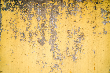  old painted yellow wall with the cracked paint