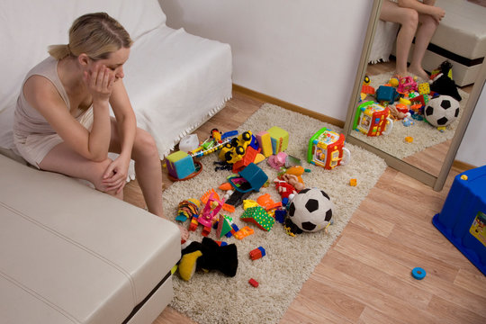 Clutter In The Nursery. Mom Is Tired Of Looking At Toys. The Mess In The House