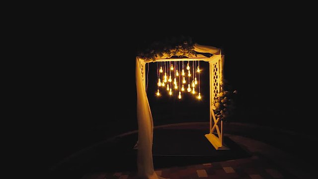 Lamps close up. Wedding garlands that glow on the arch. Vespers Wedding Ceremony