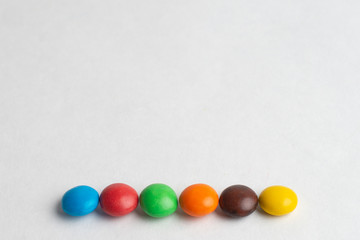 Colorful chocolate candies on the white background