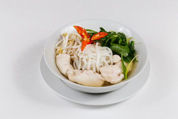 Traditional oriental cuisine of  Vietnam. Soup pho ga with rice noodles, chicken, pepper, wheat germ, greens