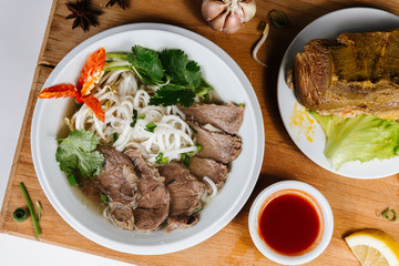 Traditional oriental cuisine of  Vietnam. Pho bo soup with rice noodles, beef, pepper, wheat germ, greens