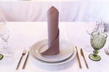 Restaurant table with glasses, napkins and cutlery