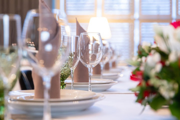 Restaurant table with glasses, napkins and cutlery