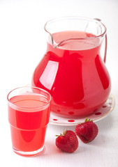 Strawberry drink in a glass jug and in  glass