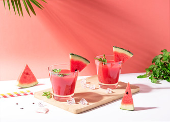 Fresh water melon juice and watermelon slice on red background. summer drink.