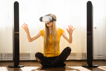 Girl wearing virtual reality goggles at home