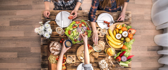 Enjoying dinner with friends. Top view of group of people having dinner together